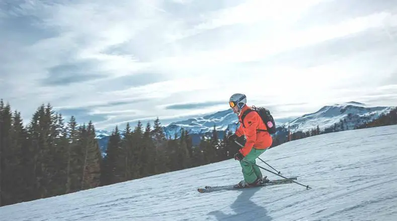 Man skiing downhill and burning calories