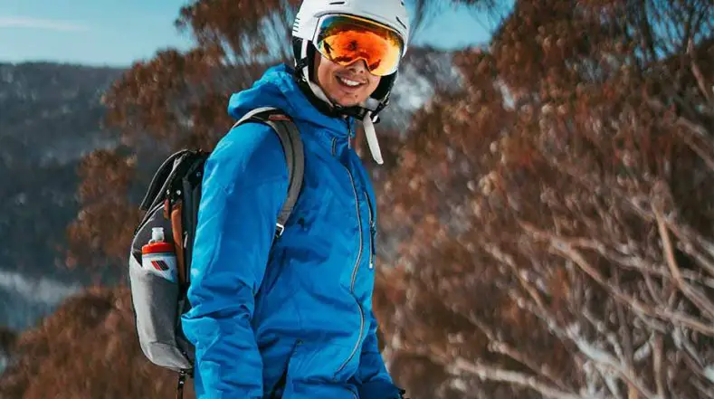 Skier carrying water bottle when skiing