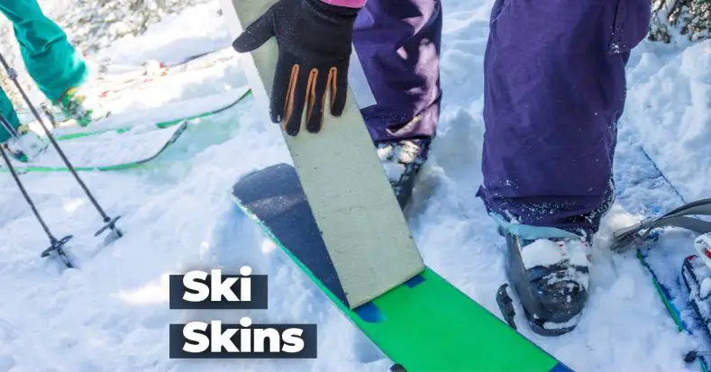 Skier applying skins to off piste skis